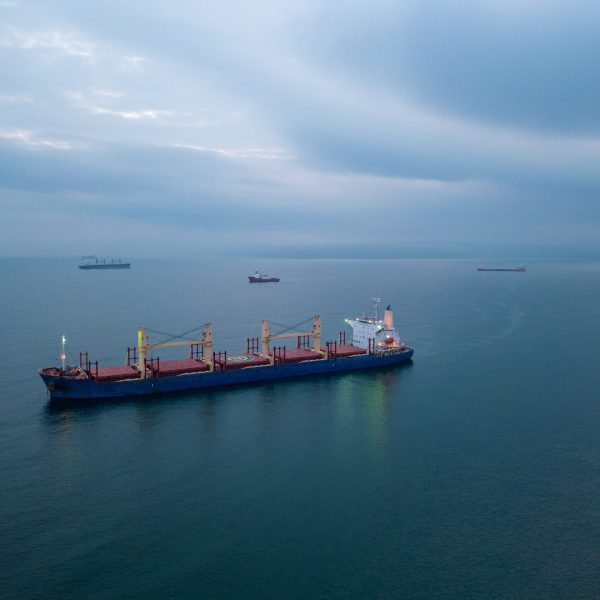 Aerial top view cargo bulk carrier ship on the sea at night