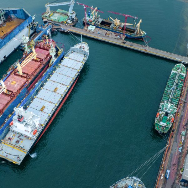 cargo container ship at dry dock concept maintenance service working in the sea. Insurance and Maintenance Cargo Ship concept. Freight Forwarding Service maintenance Insurance