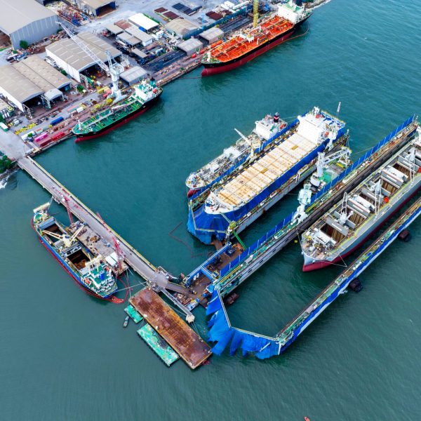cargo container ship at dry dock concept maintenance service working in the sea. Insurance and Maintenance Cargo Ship concept. Freight Forwarding Service maintenance Insurance