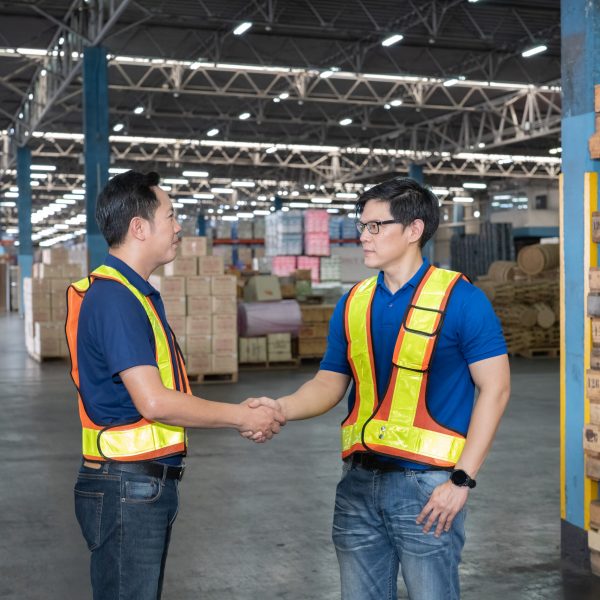 Manager and staff working in warehouse hand punch and check hand after barcode scan box completed